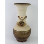 A contemporary plaster vase in cream and brown ground, 51cm high.