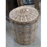 A large wickerwork lidded laundry hamper 53cm diameter.