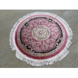 A round woolen rug, 146cm dia.