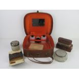 A vintage travelling vanity case with accessories.