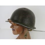 A WWII US M1 helmet, front seam,