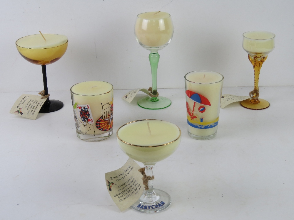 Six assorted handmade candles using vintage coloured glass wine glasses and champagne saucers etc.