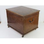 An early 20th century log box raised over brass castors, 48 x 38.5 x 38.5cm.