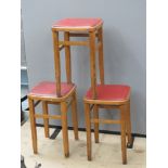 Three vintage leatherette topped stools, each 53cm high.
