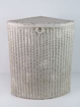 A Lloyd Loom style wicker basket, painted white.
