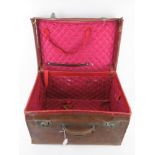 An antique silk lined leather travelling case, slightly a/f, with twin locks,