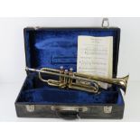 A brass trumpet with silvered mouth piece engraved B&M Champion no 2239 in fitted case.