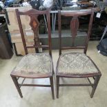 A pair of Edwardian hall chairs.