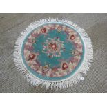 A round woolen rug, 127cm dia.