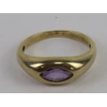 A 9ct gold amethyst ring, the marquise cut amethyst a good purple hew in rub over setting,