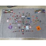 A Scouts blanket having numerous patches / badges upon inc 1977 Queen's Silver Jubilee, Boy Scouts,