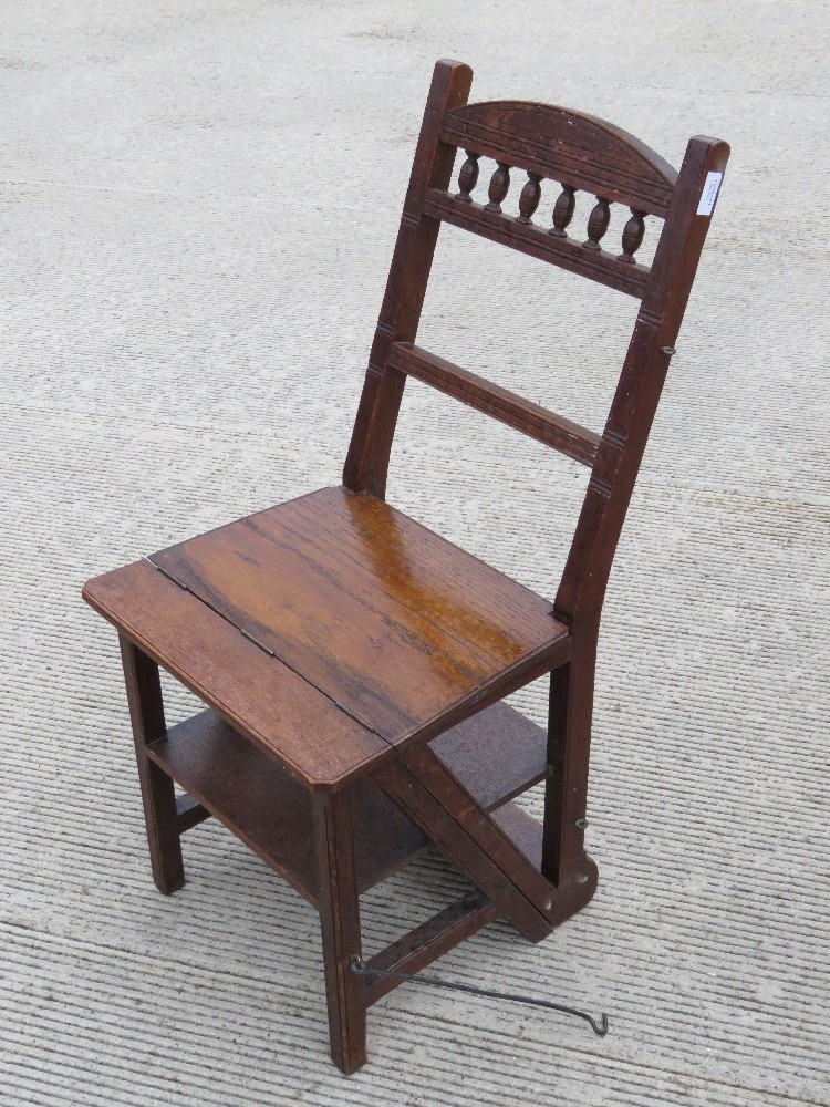 A Victorian oak metamorphic set of library steps folding to form a chair. Height of seat is 44cm.