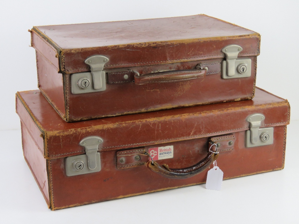 A pair of graduated pigskin leather vintage suitcases,