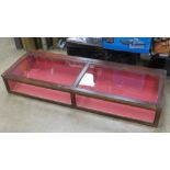 A glazed wooden museum type table top display case measuring 143 x 50.5 x 22cm.
