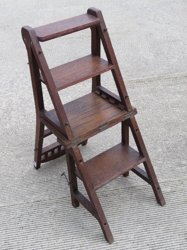 A Victorian oak metamorphic set of library steps folding to form a chair. Height of seat is 44cm. - Image 2 of 2
