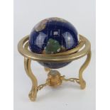 A tabletop blue lapis ocean gemstone globe,