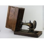 A vintage sewing machine by Frister and Rossmann in original case (case a/f).