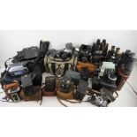 A large collection of vintage and contemporary cameras and binoculars inc Canon AE-1,