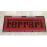 A large Ferrari-themed garage wall sign.