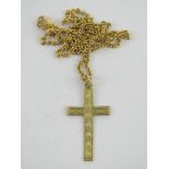 A 9ct gold crucifix having engine turned engraving upon, stamped 9ct,