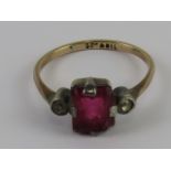 An early 20thC 9ct gold and silver ring having octagonal cut, red glass stone centre,