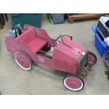 A vintage 'fire engine' pedal car having FD emblem upon, in unrestored condition,