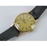A 9ct gold ladies Omega wristwatch having champagne dial marked for Omega, crown wheel, strap,