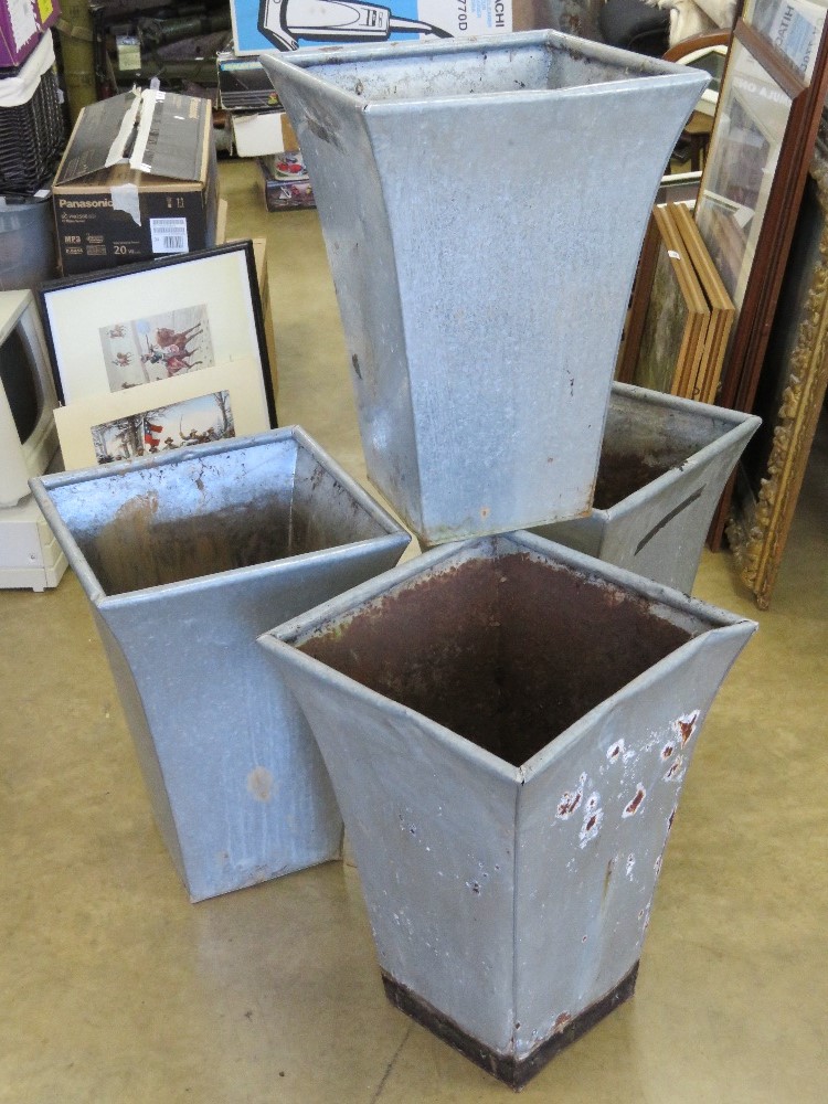 A set of four galvanised planters, each standing 52cm high, 37 x 37cm square at top.