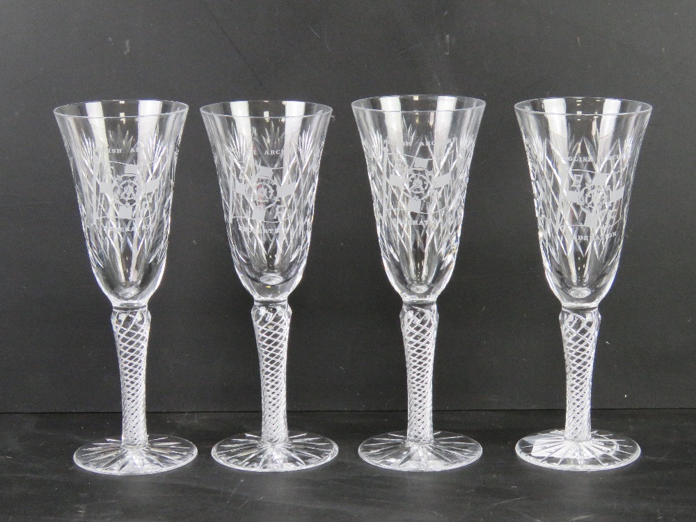 A set of four English Archery Federation cut glass wine glasses.