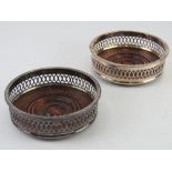 A pair of Georgian style silver plated mahogany based wine stands having fretted sides, 13.5cm dia.