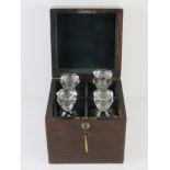 A fine Victorian rosewood tantalus having flush fitting swing handle to the lid,