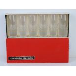 A boxed set of six tall shot glasses with solid spun bases within original box bearing label