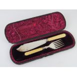 A boxed presentation fish serving set comprising plated knife and fork with ivorine handles.