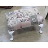 A Parker Knoll footstool re upholstered in chintz French patisserie fabric,
