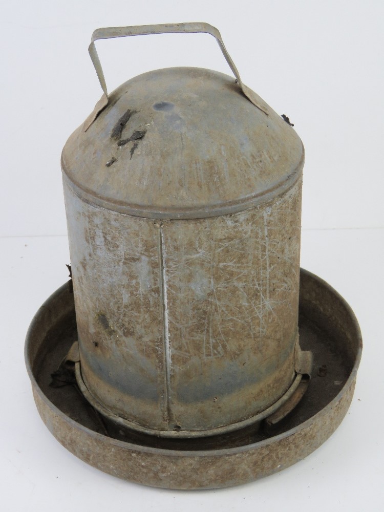 A small chicken feeder, 30cm high.