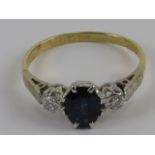 An 18ct gold sapphire and diamond ring, the central blue oval cut sapphire approx 0.