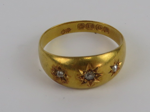 An 18ct gold Gypsy ring having three star set diamonds, hallmarked Birmingham, size M, 2.6g.