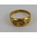 An 18ct gold Gypsy ring having three star set diamonds, hallmarked Birmingham, size M, 2.6g.