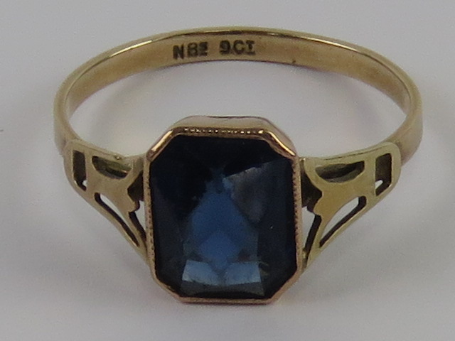 A delightful Art Deco 9ct rose gold ring having central octagonal faceted royal blue glass stone,