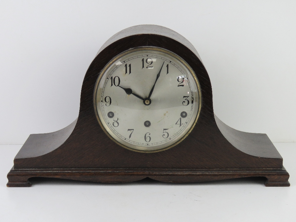 A three train Napoleon hat mantle clock by Garrards, silvered dial with Arabic numerals,