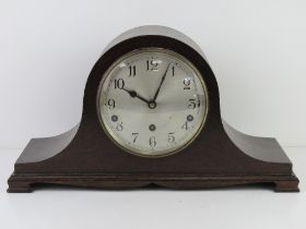 A three train Napoleon hat mantle clock by Garrards, silvered dial with Arabic numerals,
