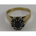 A 9ct gold diamond and sapphire cluster ring, hallmarked 375, size S, 4.7g.