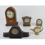An ebonised small size mantle clock having brass chaptering together with an Edwardian arch top
