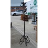 Of equine interest; a heavy metal hat and coat stand formed from horse shoes standing 187cm high.