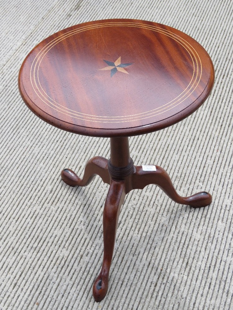 A contemporary mahogany tripod table having inlaid decoration,