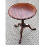 A contemporary mahogany tripod table having inlaid decoration,