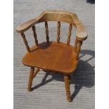 A contemporary smokers type bow back armchair having ring turned decoration throughout.