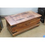 A Mexican pine coffee table having black painted iron corner bracing and lift up lidded compartment