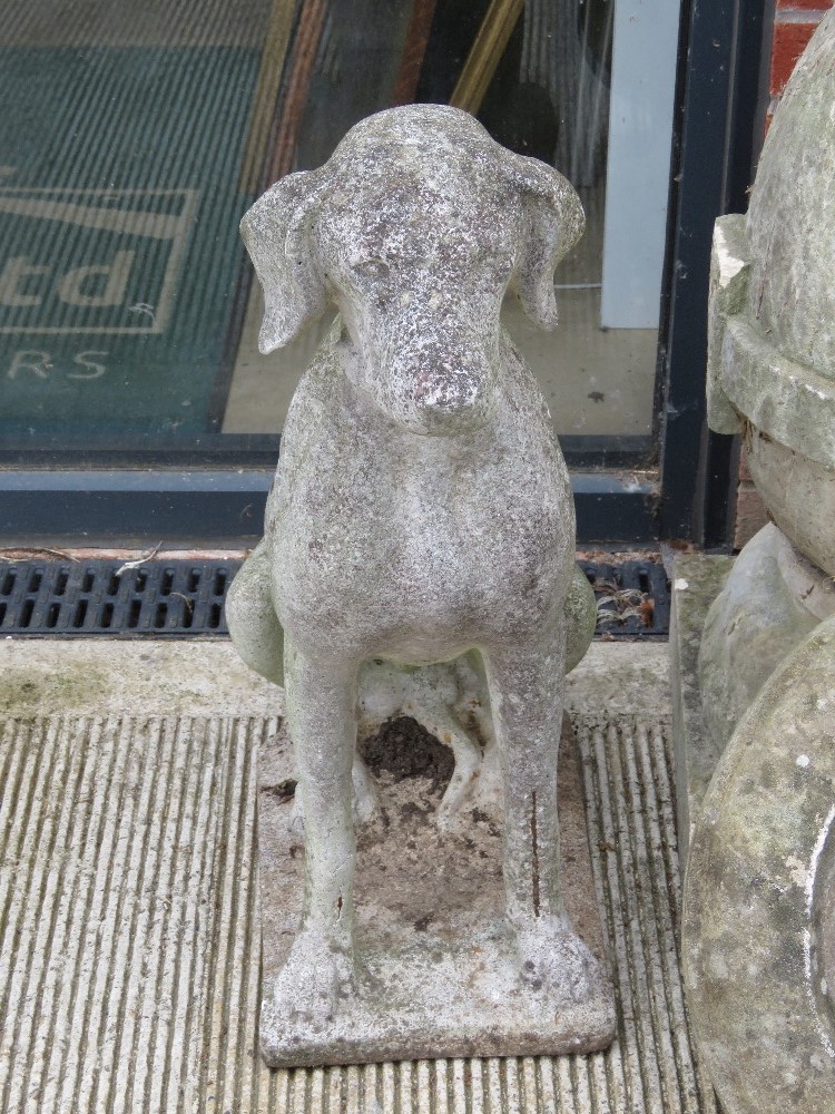 A pre-cast garden statue of a dog.