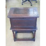 An oak cabinet lid lifting to reveal compartment within, having brass lock with key, 51.